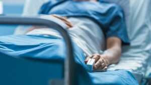 A man lying in a hospital bed. A Lehigh Acres catastrophic injury attorney can help you get compensation for your losses.